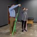 Two people using resistance bands in a therapy or exercise setting.