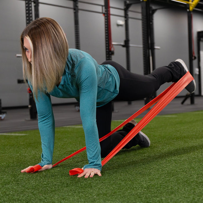 Woman exercising with resistance bands in a gym setting