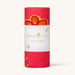 Roll of Karma Luck yoga towel with red and orange design on a white background