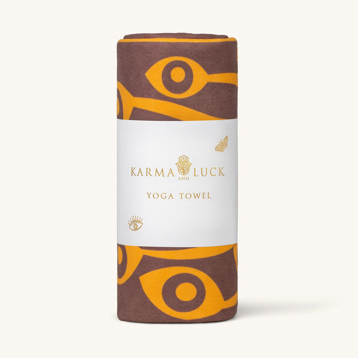Karma Luck yoga towel with brown and yellow design on a white background