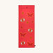 Red yoga mat with butterfly and eye designs on a white background