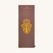Brown yoga towel with yellow Hamsa hand design and 'Karma Luck' branding on a white background