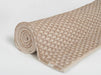 Rolled-up beige textured yoga mat on a white background