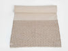 Textured yoga mat with grippy geometric pattern on a white background